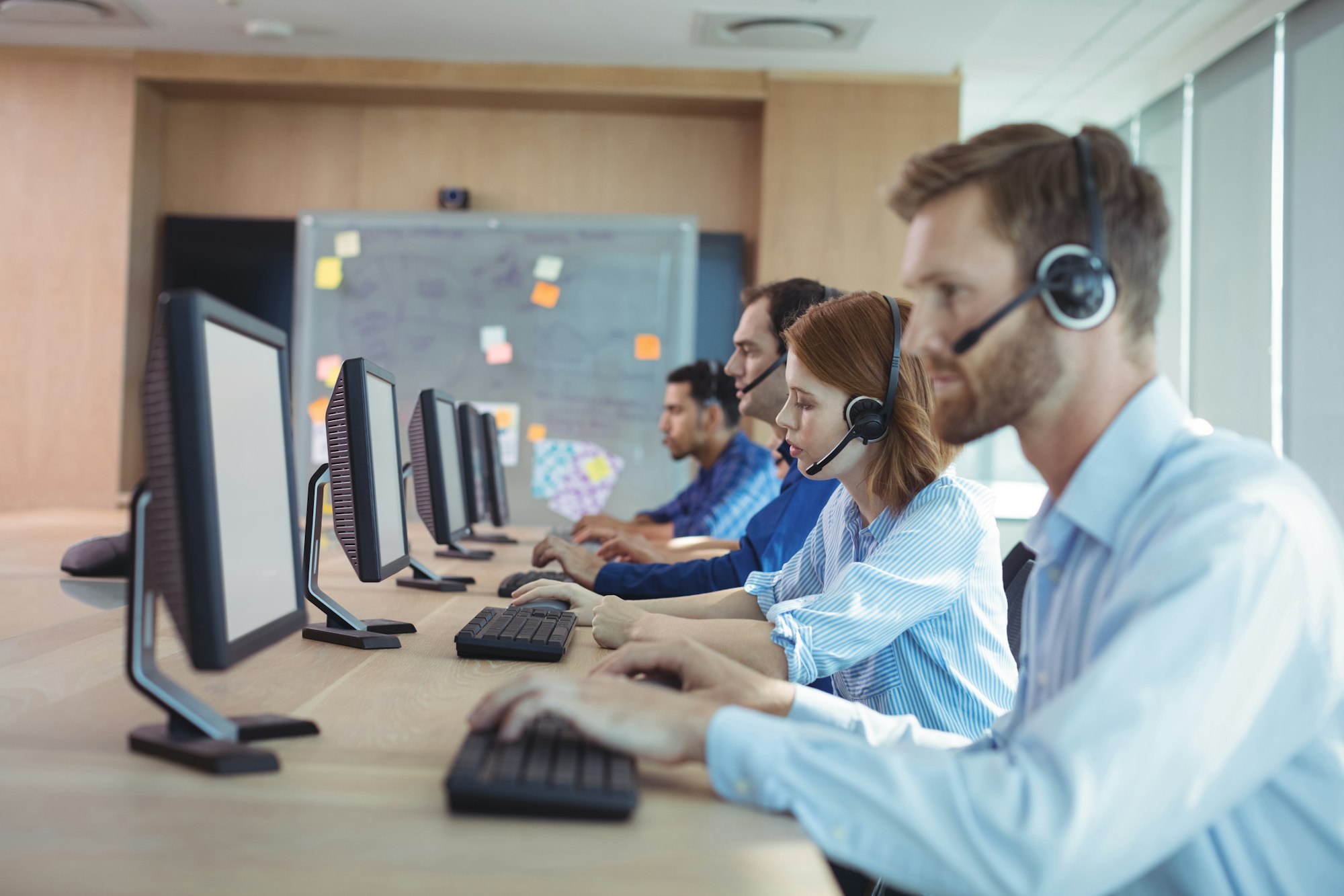 Side view of business people working at call center