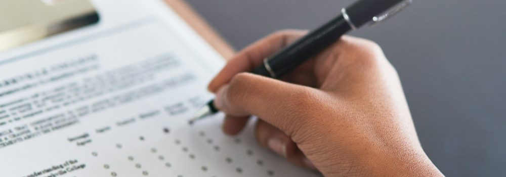 Completing the survey. Cropped shot of an unrecognizable businesswoman filling in a questionnaire.